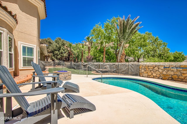 view of swimming pool featuring a fenced backyard, a fenced in pool, and a patio