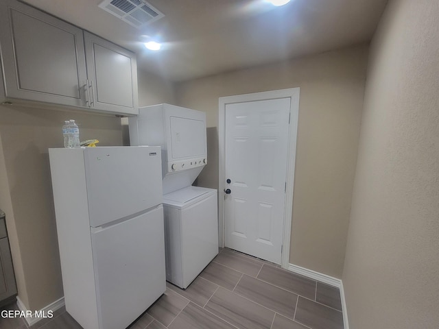11531 Ernest Rd, Socorro, TX 79927 - clothes washing area with stacked washing machine and dryer and baseboards