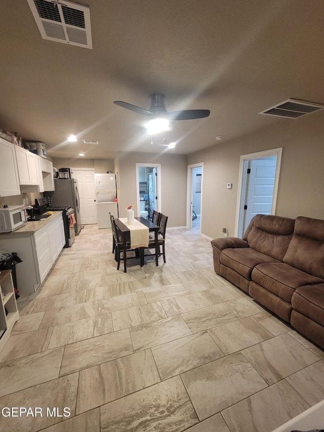 11531 Ernest Rd, Socorro, TX 79927 - living area with a ceiling fan, recessed lighting, light stone finish flooring, and baseboards
