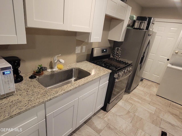 11531 Ernest Rd, Socorro, TX 79927 - kitchen featuring stainless steel appliances, white cabinets, a sink, and light stone counters