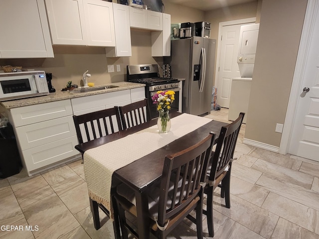 11531 Ernest Rd, Socorro, TX 79927 - dining area with estacked washer and dryer