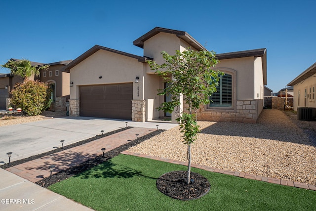 12244 Desert Snow Ct, El Paso, TX 79938 - view of front of house with driveway, stone siding, stucco siding, central AC unit, and a garage