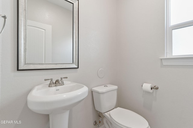 half bath with a sink and toilet