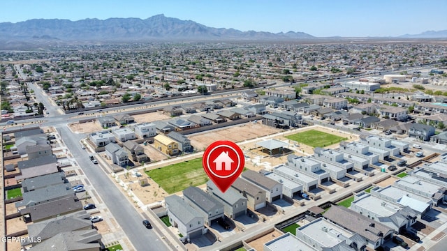 drone / aerial view featuring a residential view and a mountain view
