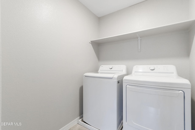 laundry room featuring washer and dryer, laundry area, and baseboards