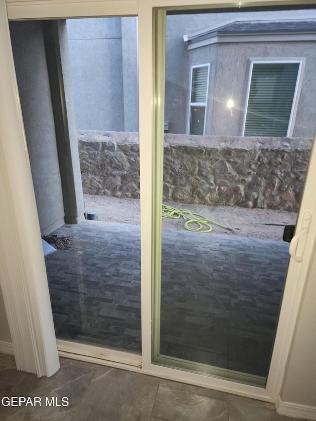 doorway featuring baseboards