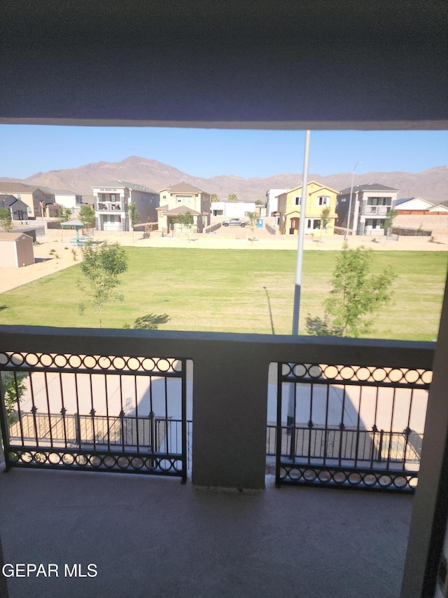 view of gate featuring a residential view and a mountain view