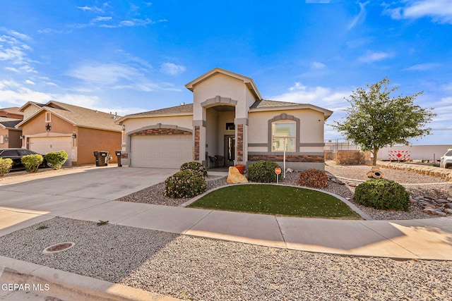 mediterranean / spanish-style home with an attached garage, stucco siding, driveway, and stone siding