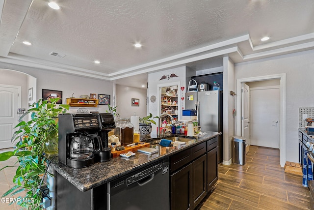 kitchen with a sink, arched walkways, dark stone countertops, black dishwasher, and wood tiled floor