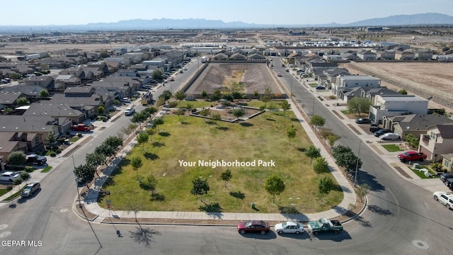 drone / aerial view featuring a residential view and a mountain view