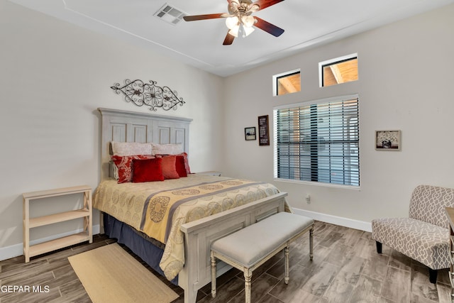 bedroom with visible vents, baseboards, and multiple windows