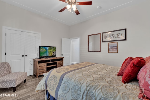 bedroom featuring a closet, ceiling fan, and wood finished floors