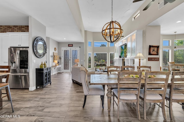 dining area with wood finished floors, visible vents, recessed lighting, and ceiling fan with notable chandelier