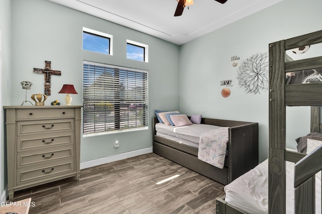 bedroom featuring ceiling fan, wood finished floors, and baseboards