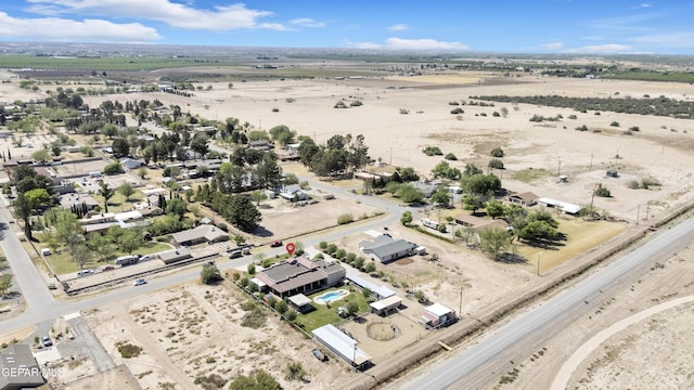 birds eye view of property featuring a rural view and a desert view