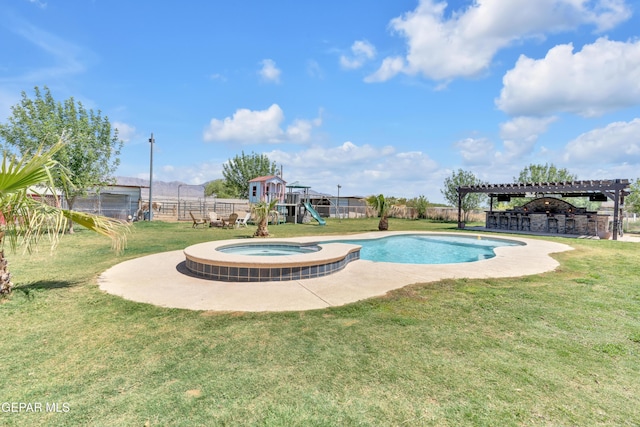 view of pool featuring fence, a lawn, a pool with connected hot tub, and a playground