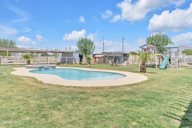 view of pool with a pool with connected hot tub, fence, a yard, and a playground