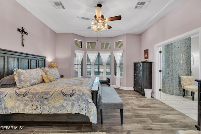bedroom with wood tiled floor, a ceiling fan, visible vents, and baseboards