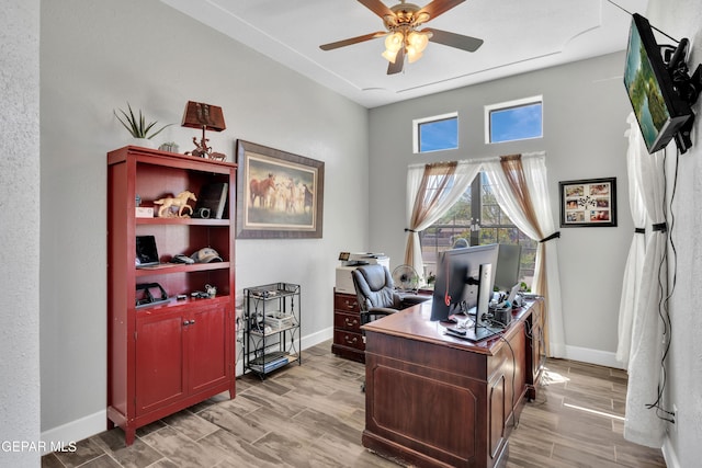 office with baseboards, ceiling fan, and light wood finished floors
