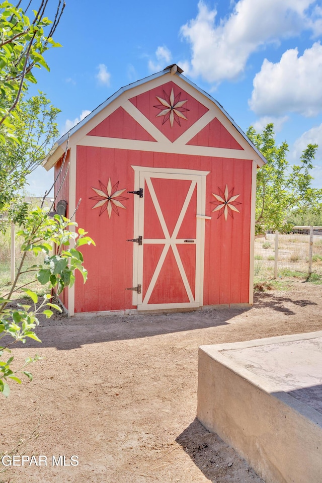 view of shed featuring fence