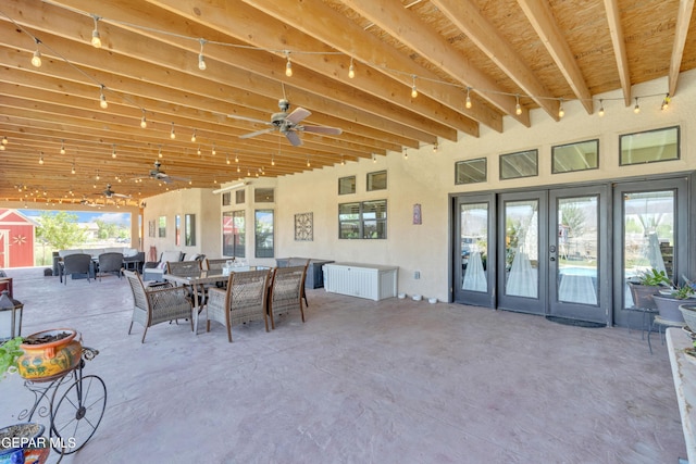 view of patio with outdoor dining space, ceiling fan, and french doors
