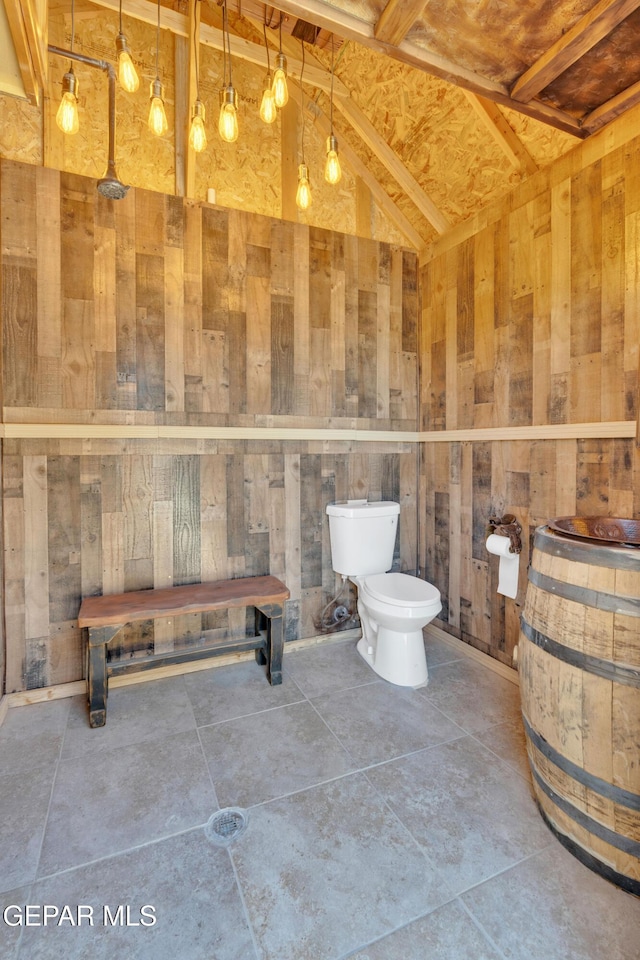 bathroom with toilet and tile patterned flooring