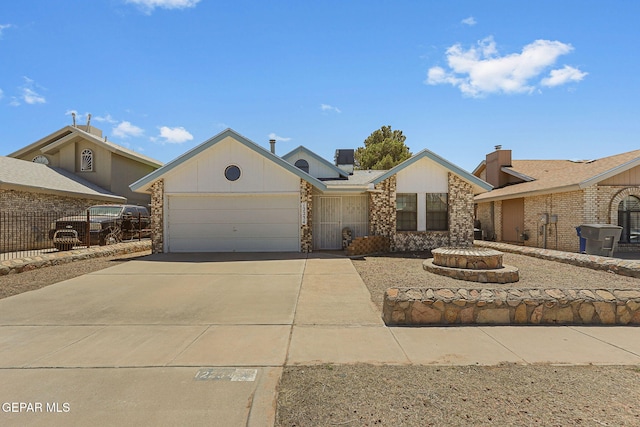 single story home featuring an attached garage and driveway