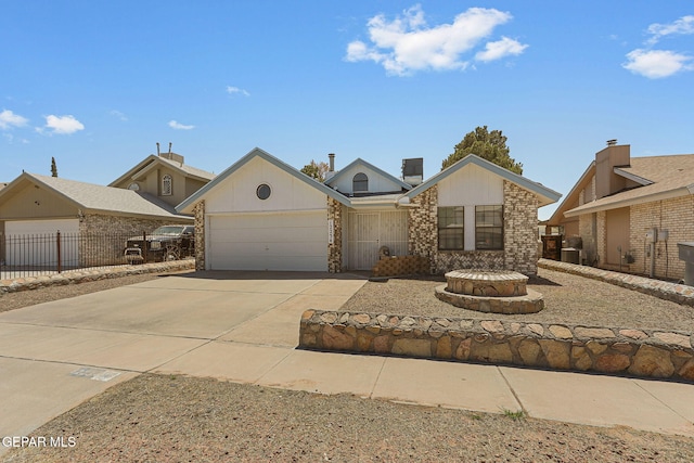 view of front of house with brick siding, a garage, fence, and driveway