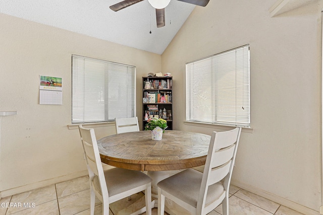 dining space featuring light tile patterned floors, baseboards, ceiling fan, and vaulted ceiling