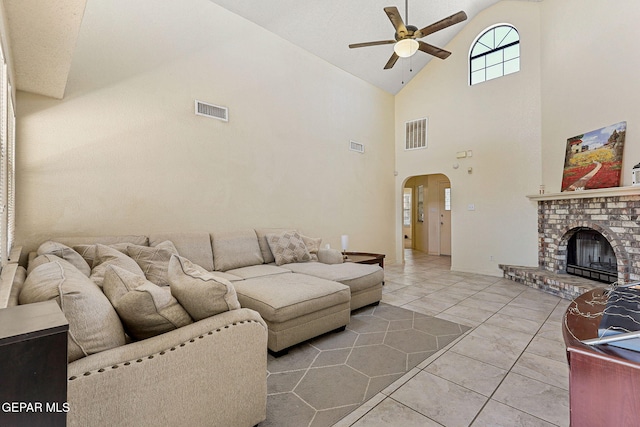 living room featuring arched walkways, ceiling fan, visible vents, and high vaulted ceiling