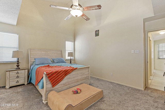 carpeted bedroom featuring baseboards and a ceiling fan