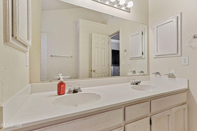 full bathroom featuring double vanity and a sink