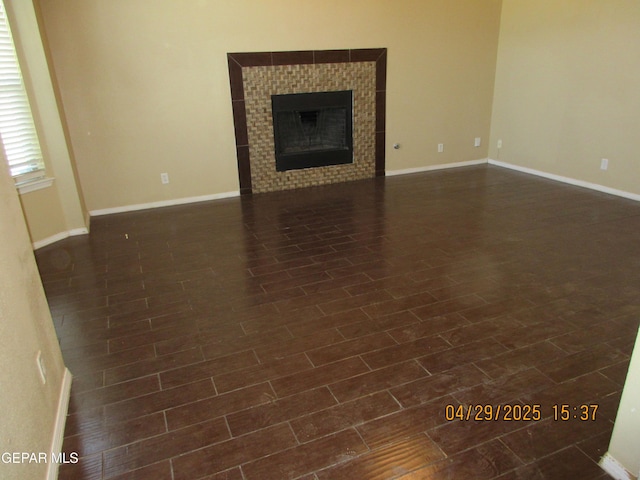 11233 Red Barrel Pl, El Paso, TX 79934 - unfurnished living room featuring a fireplace, baseboards, and dark wood-type flooring