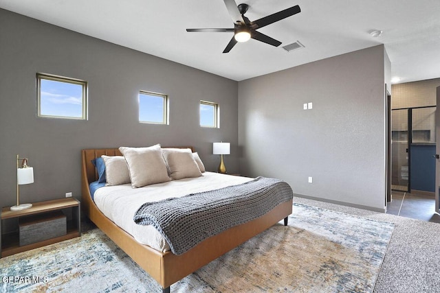 bedroom with visible vents, ceiling fan, baseboards, and multiple windows