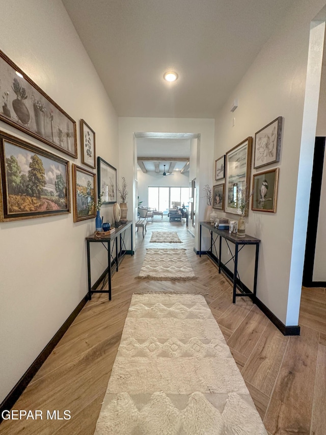hallway featuring recessed lighting, wood finished floors, and baseboards