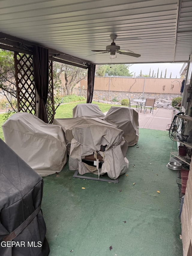 view of patio with fence, ceiling fan, and grilling area