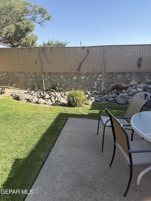 view of yard with fence and a patio