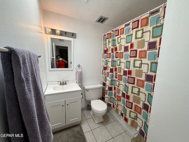 bathroom featuring toilet, tile patterned floors, a textured ceiling, vanity, and a shower with curtain