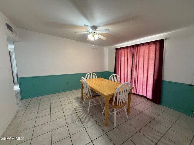 dining area with a ceiling fan and light tile patterned floors