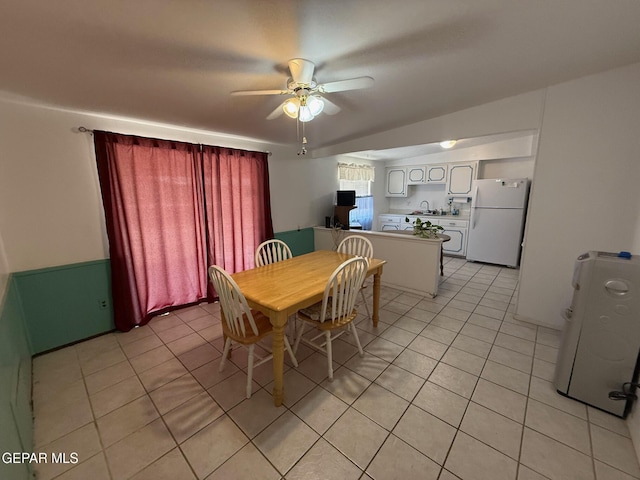 dining room with light tile patterned floors and a ceiling fan