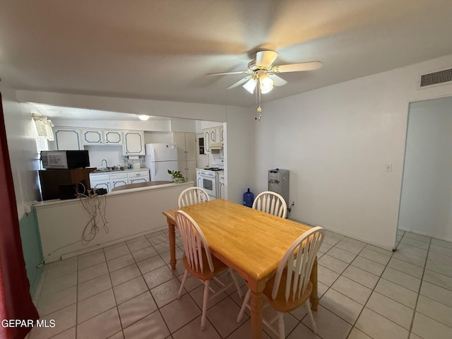 dining room featuring light tile patterned floors and ceiling fan