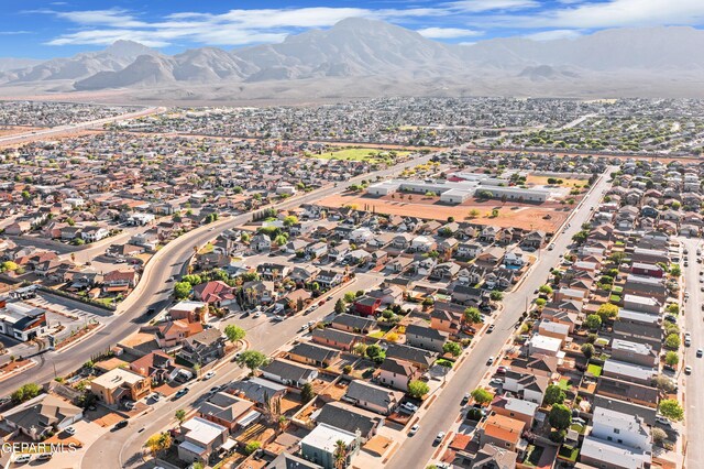 view of property location featuring mountains and nearby suburban area
