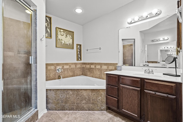 bathroom featuring a stall shower, a bath, and vanity