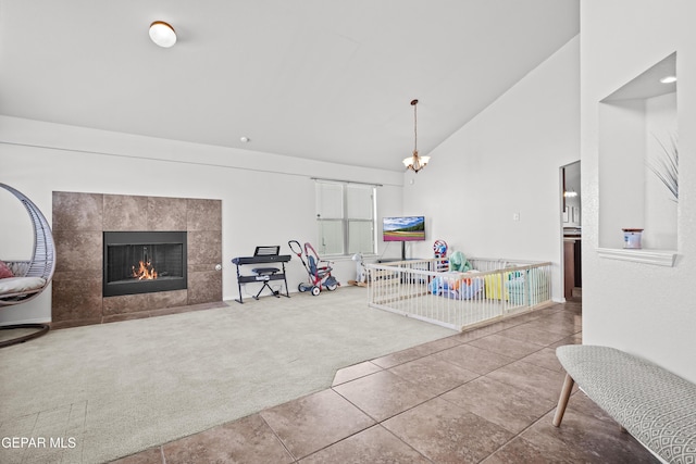 carpeted living area featuring a fireplace, high vaulted ceiling, and tile patterned flooring