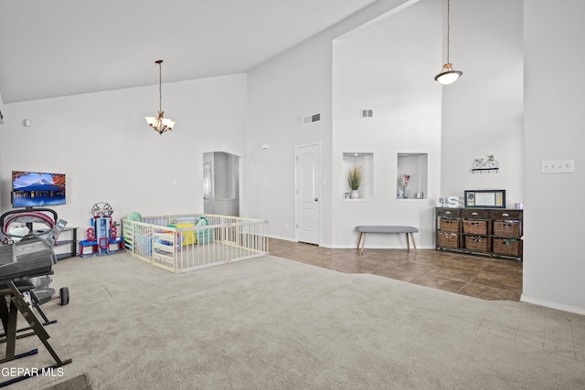 carpeted living area with high vaulted ceiling, baseboards, a chandelier, arched walkways, and tile patterned floors