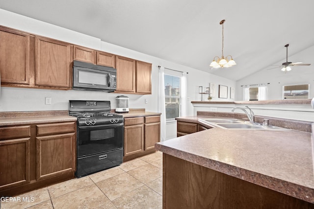kitchen with black appliances, a sink, plenty of natural light, vaulted ceiling, and hanging light fixtures