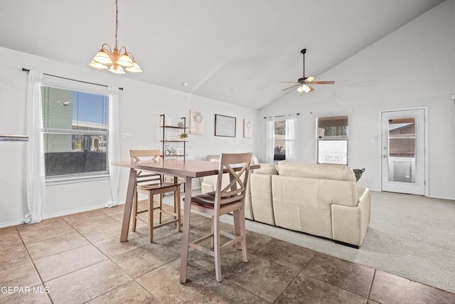 dining area featuring a chandelier, high vaulted ceiling, ceiling fan, baseboards, and light tile patterned flooring