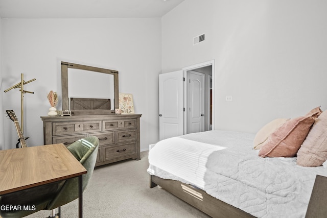 bedroom with light colored carpet and high vaulted ceiling