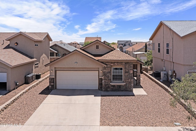 view of front of property with an attached garage, cooling unit, stone siding, and driveway