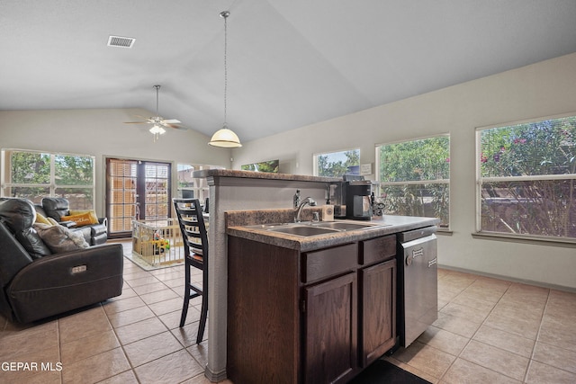kitchen with a sink, open floor plan, stainless steel dishwasher, vaulted ceiling, and light tile patterned flooring